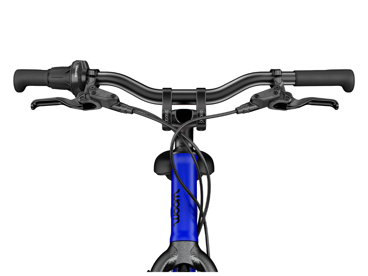 Woom Explore 4 har 7 gir, skivebremser og terrengdekk. Robust sykkel for barn 6–8 år (115–130 cm).	