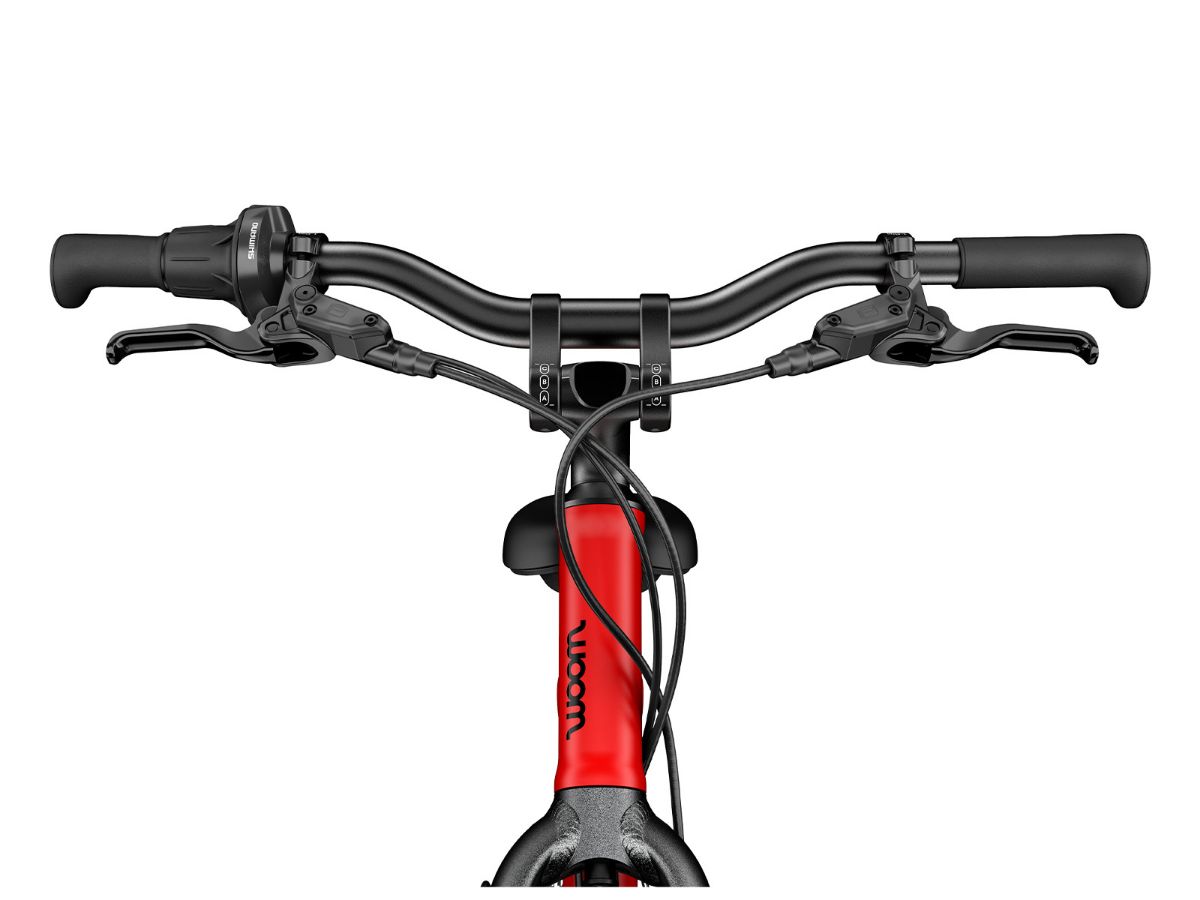 Woom Explore 4 har 7 gir, skivebremser og terrengdekk. Robust sykkel for barn 6–8 år (115–130 cm).	